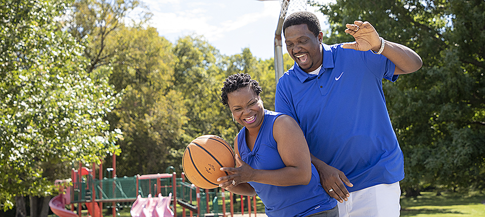 Man in blue nike jersey shirt holding basketball