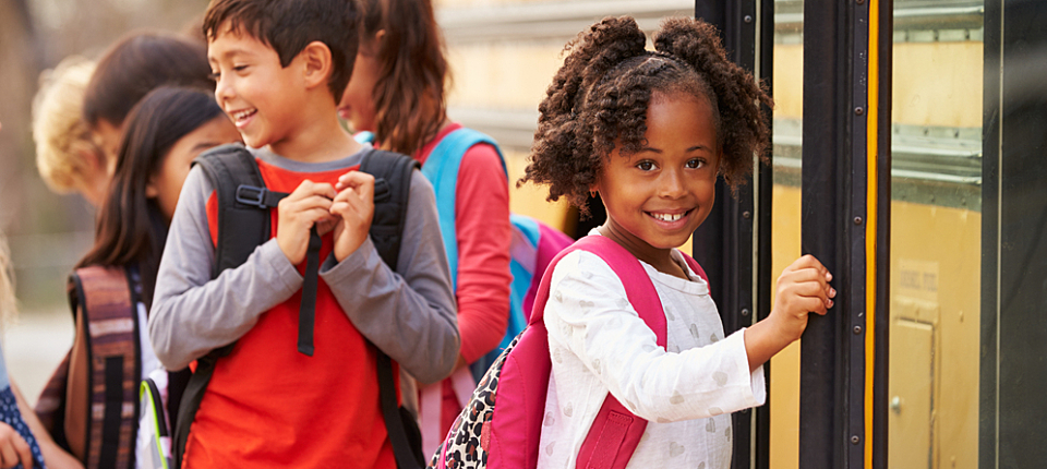 Elementary school girl at the front of the school bus queue; Shutterstock ID 388630468; PO: 123